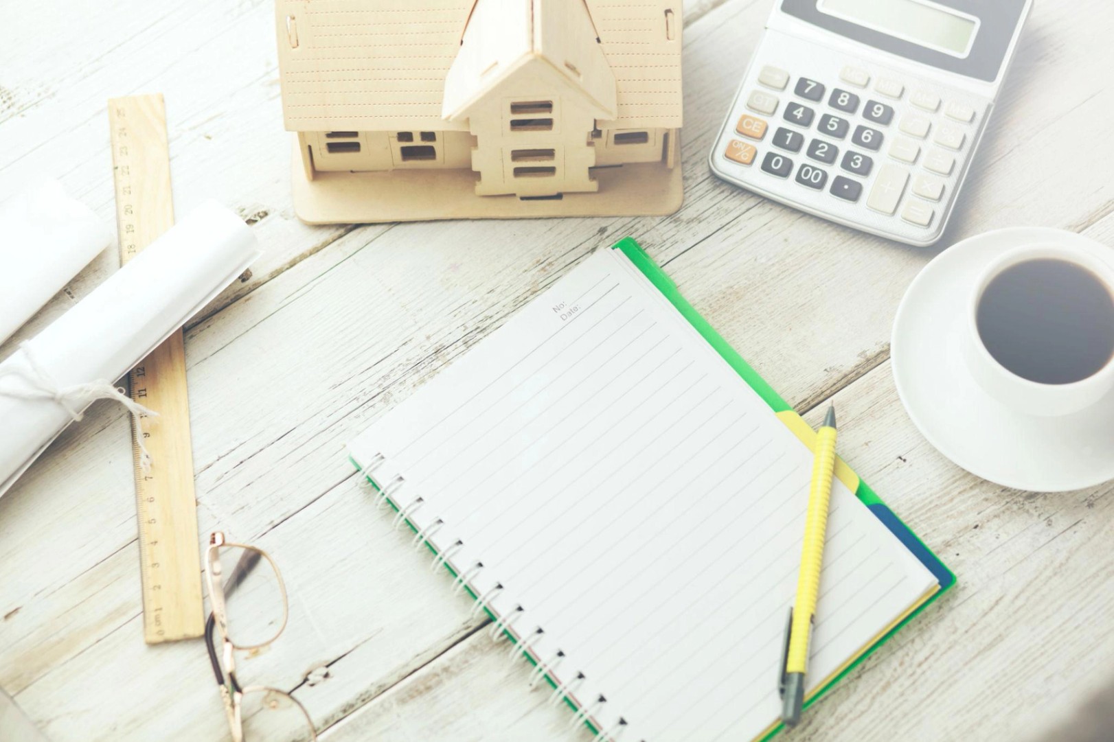 house model with notepad on wooden table