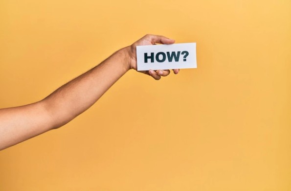 Hand of caucasian man holding paper with how word over isolated white  background | Free Photo
