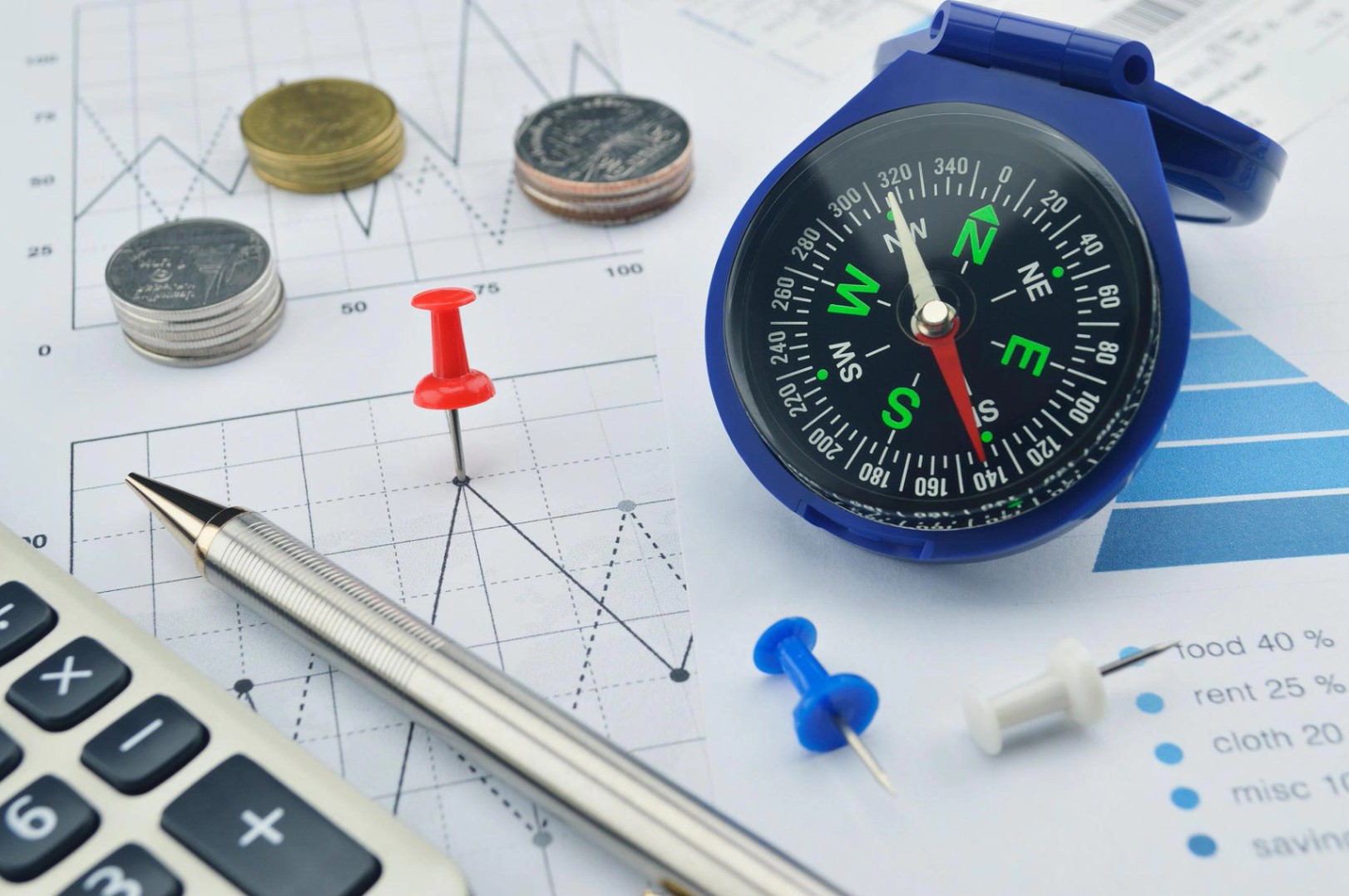 Pin and compass on graph paper, target and win concept